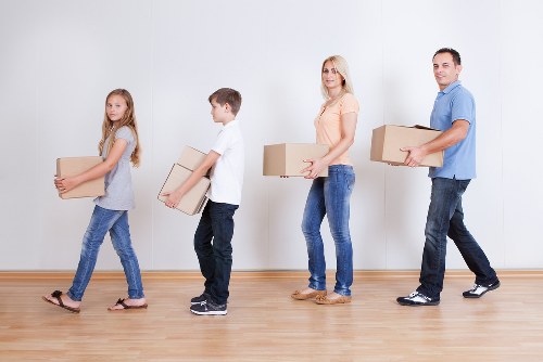 Professional movers handling office equipment in central London